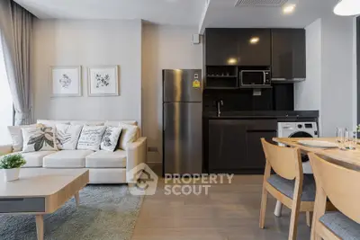 Modern open-plan living room and kitchen with stylish furniture and appliances