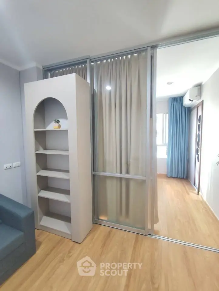 Modern apartment interior with sliding glass doors and wooden flooring