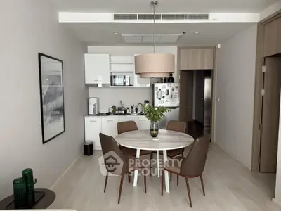 Modern dining area with stylish furniture and open kitchen layout
