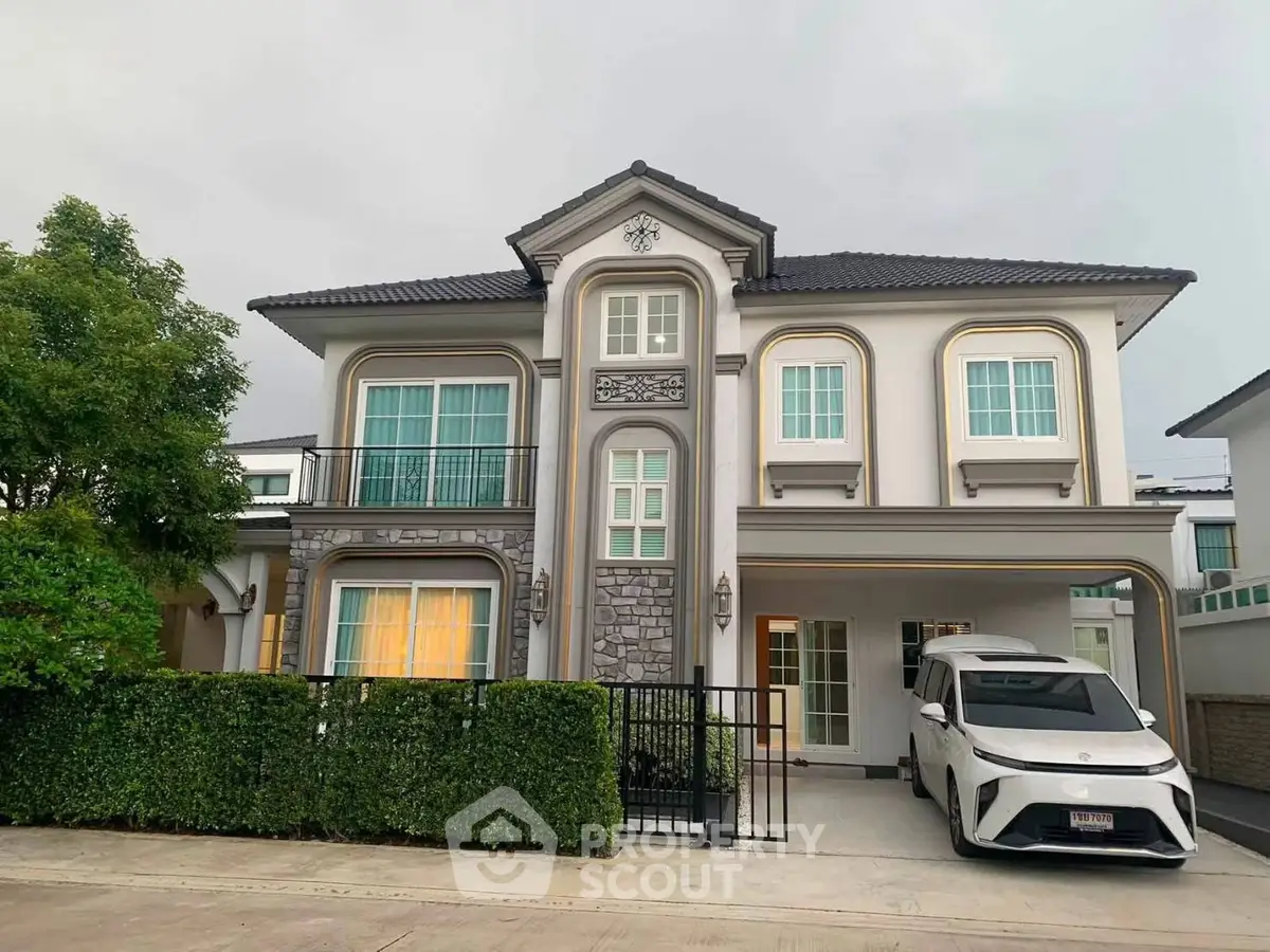 Elegant two-story house with modern facade and spacious driveway in a serene neighborhood.