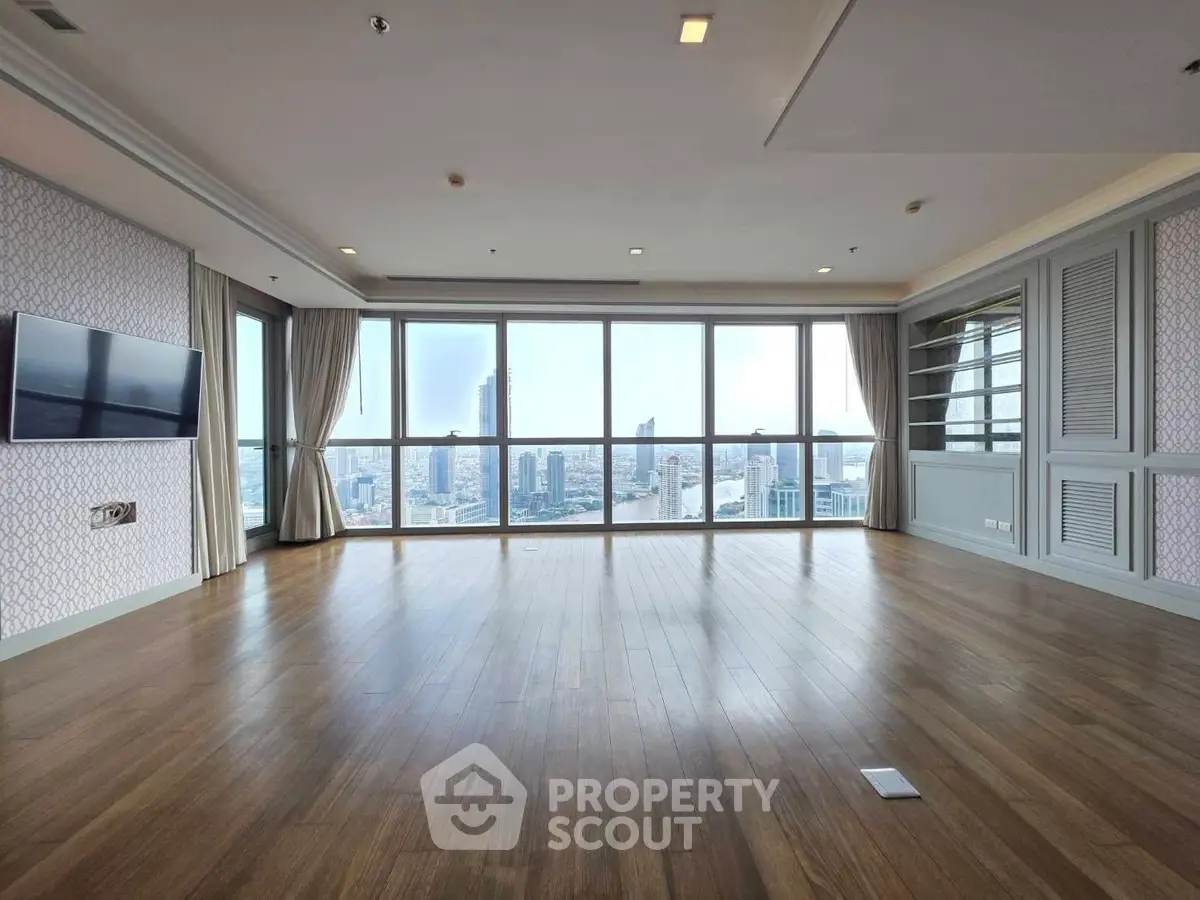 Spacious living room with panoramic city view and hardwood floors