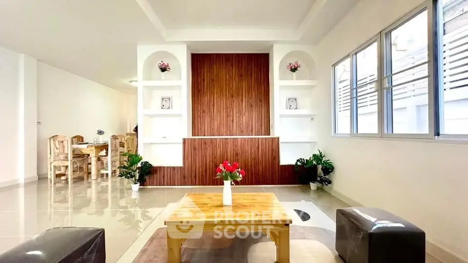 Spacious living room with elegant wooden accents and natural light