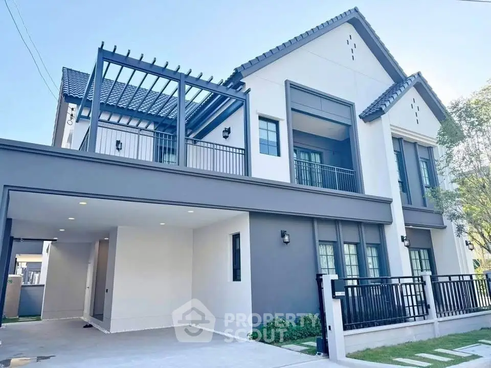 Modern two-story house with sleek design and spacious driveway in a serene neighborhood.
