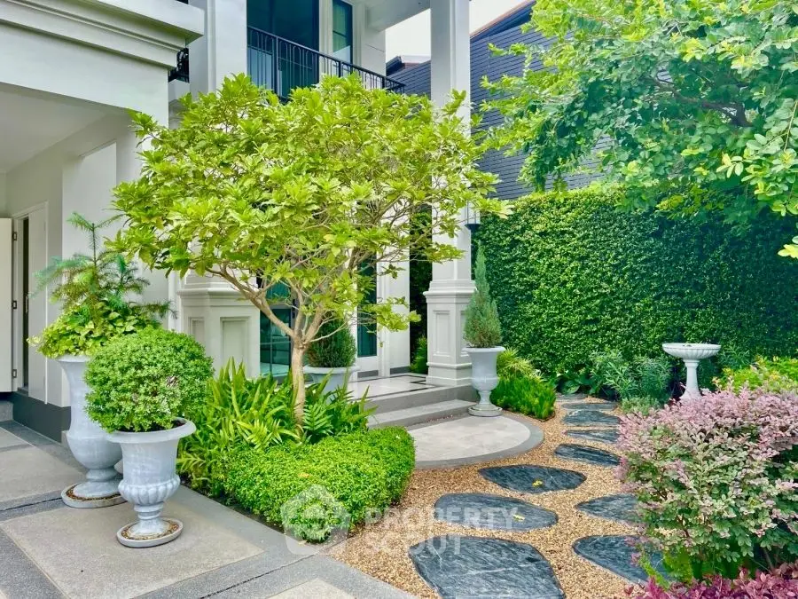 Luxurious garden entrance with lush greenery and elegant landscaping