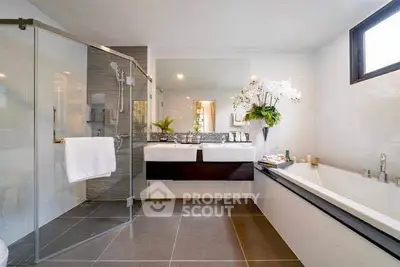 Luxurious modern bathroom with glass shower and elegant bathtub