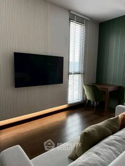 Modern living room with wall-mounted TV and stylish furniture