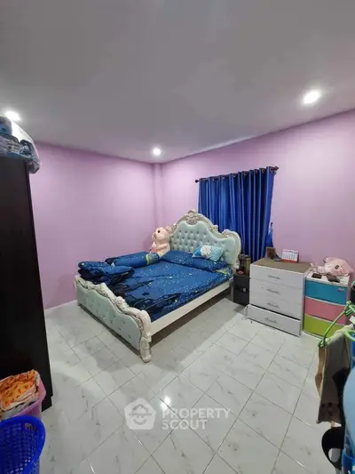 Charming bedroom with elegant bed and vibrant decor, perfect for cozy living.