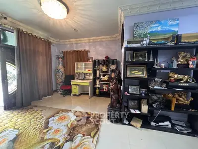 Elegant living room with ornate decor and large window, showcasing luxurious interior design.