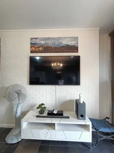 Modern living room with wall-mounted TV and stylish decor