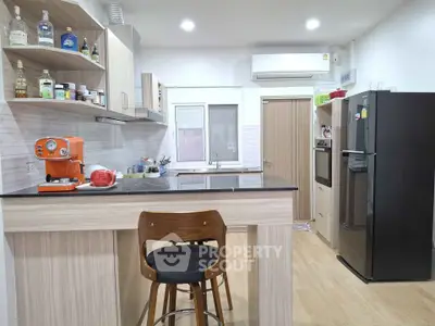Modern kitchen with sleek appliances and stylish bar seating