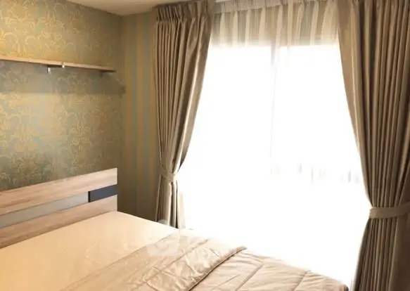 Cozy bedroom with elegant wallpaper and natural light