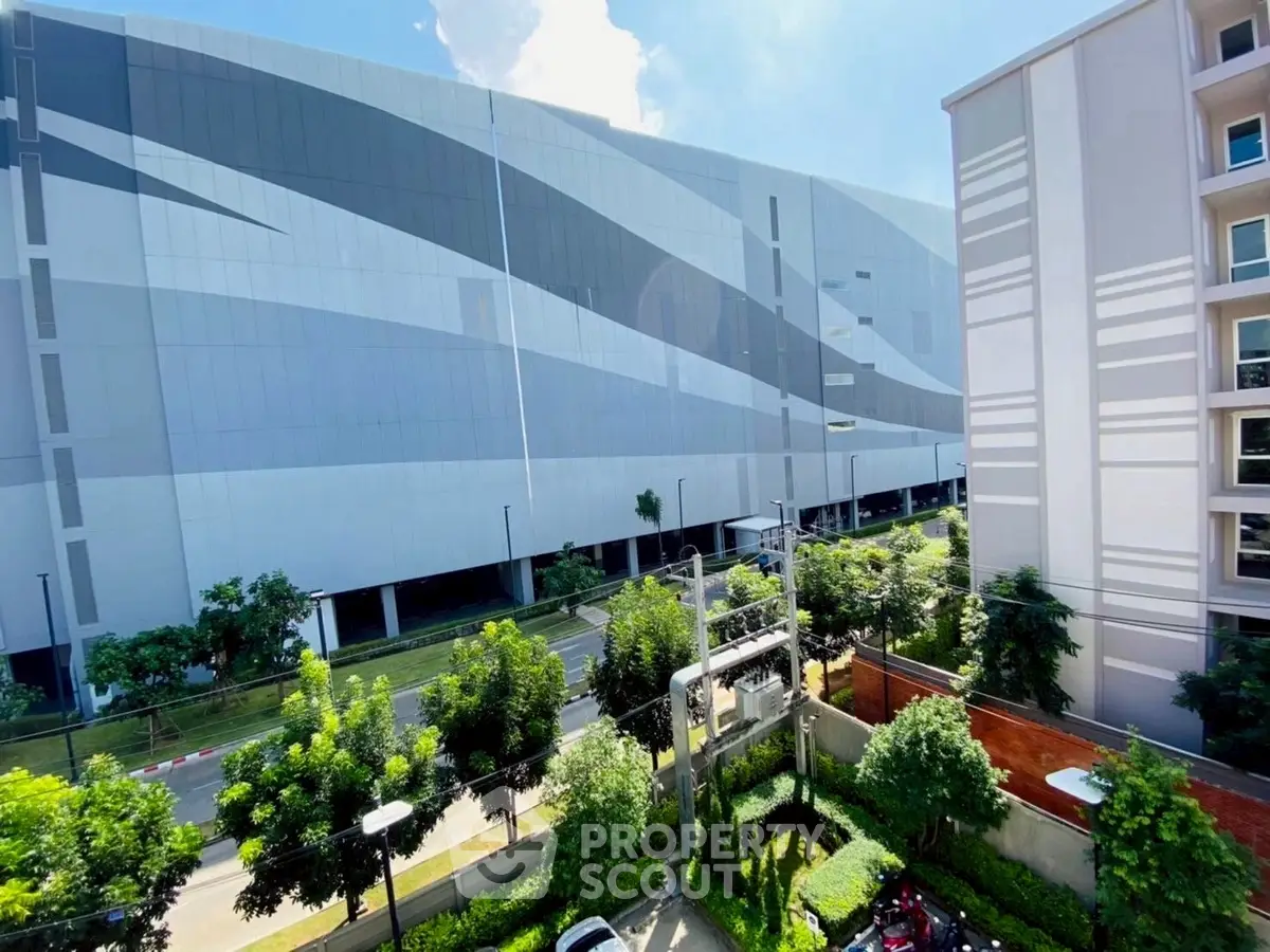Modern building exterior with sleek design and lush greenery, perfect for urban living.