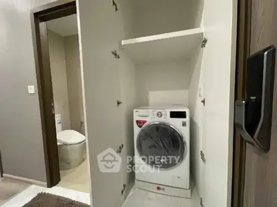 Modern apartment with built-in washing machine and sleek bathroom design.