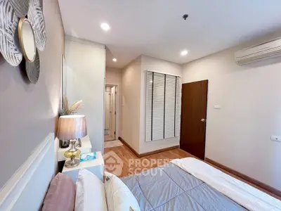 Cozy bedroom with modern decor and soft lighting, featuring a comfortable bed and stylish wall art.