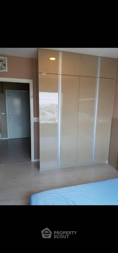 Modern bedroom with sleek built-in wardrobe and minimalist design