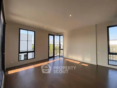Spacious corner unit with large windows and hardwood floors offering abundant natural light.