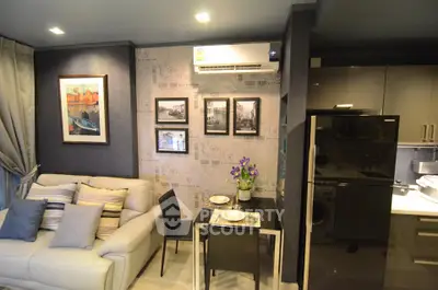 Modern living room with stylish decor and compact dining area in a cozy apartment.