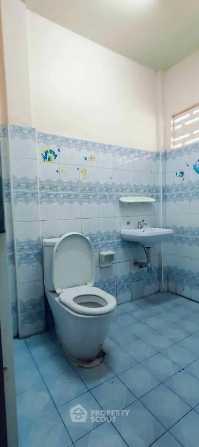 Spacious bathroom with blue tile design and modern fixtures