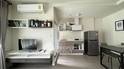 Modern studio apartment with sleek kitchen and cozy living area, featuring air conditioning and stylish decor.