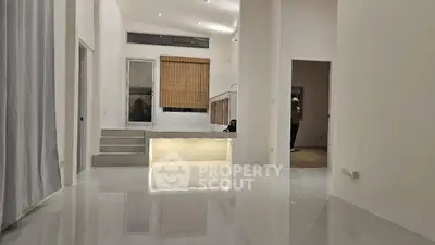 Spacious modern living room with high ceilings and sleek tile flooring