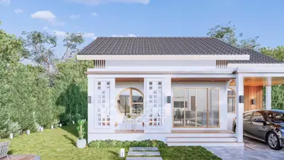 Charming modern house with unique circular window and lush garden, perfect for serene living.