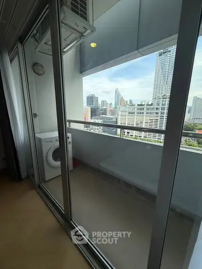 Modern apartment balcony with city skyline view and washing machine