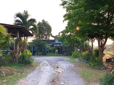 Charming countryside home with lush greenery and spacious driveway, perfect for serene living.