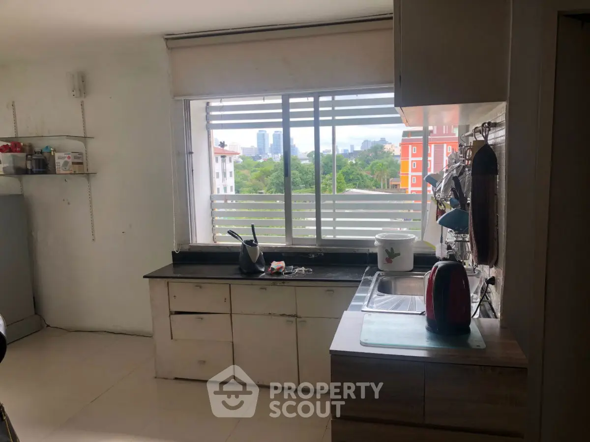 Charming kitchen with city view, featuring modern appliances and ample natural light.
