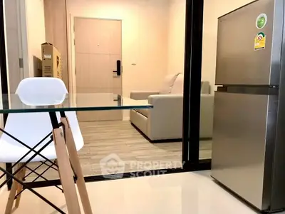 Modern apartment interior with sleek furniture and stainless steel fridge