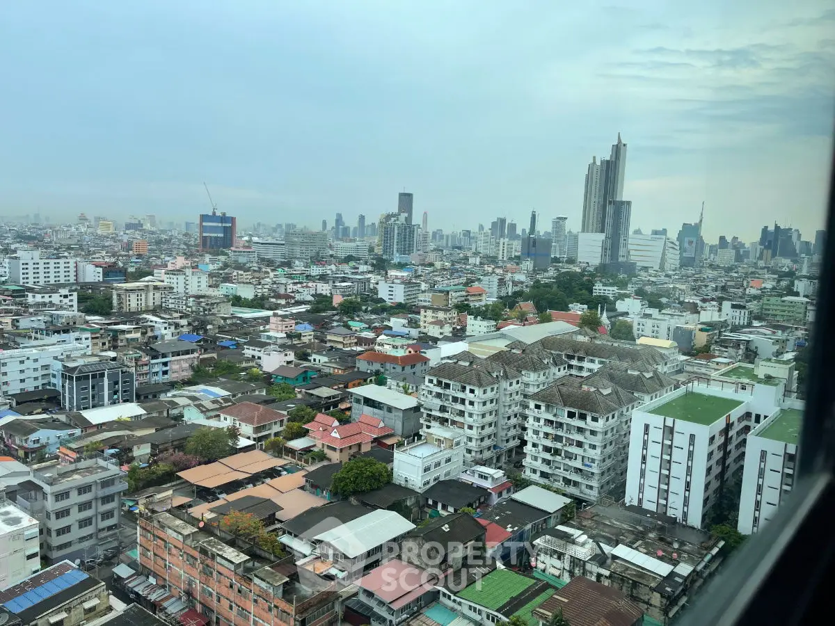 Stunning cityscape view from high-rise building window showcasing urban skyline.