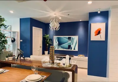 Modern living room with stylish decor and vibrant blue accent wall