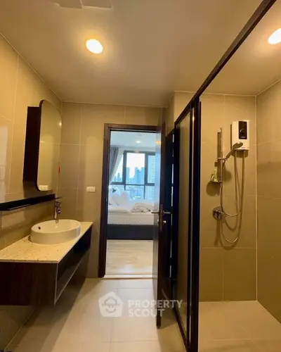 Modern bathroom with sleek design and city view from adjacent bedroom