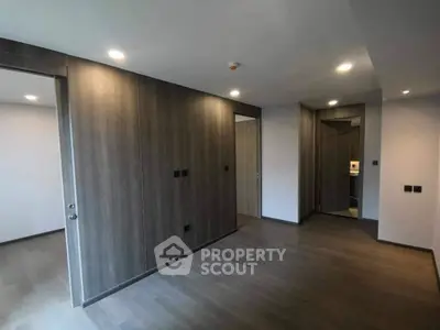 Spacious modern room with sleek wooden paneling and recessed lighting