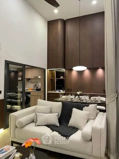 Luxurious living room with high ceiling and modern kitchen in open layout