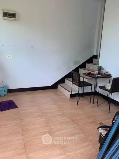 Cozy interior space with staircase and minimalist furniture setup