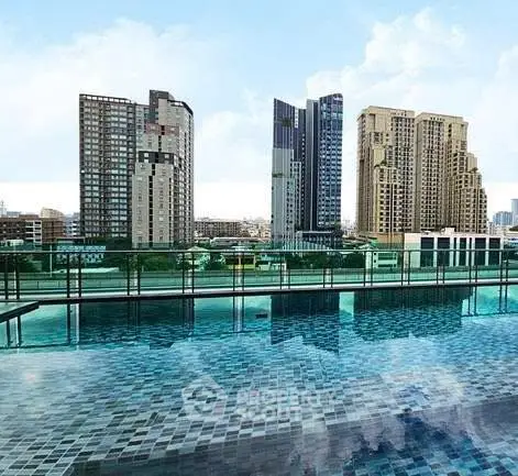 Luxurious rooftop pool with stunning city skyline views in modern high-rise building.