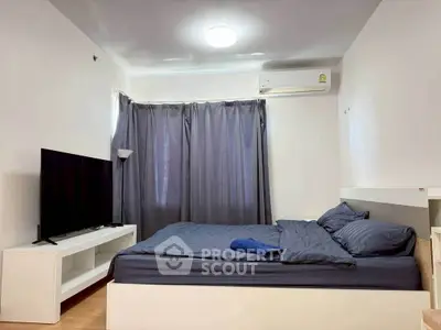Modern bedroom with sleek design, featuring a large bed, flat-screen TV, and air conditioning for ultimate comfort.