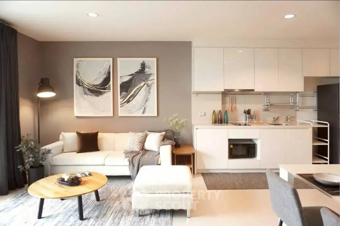 Modern living room with open kitchen, stylish decor and cozy ambiance