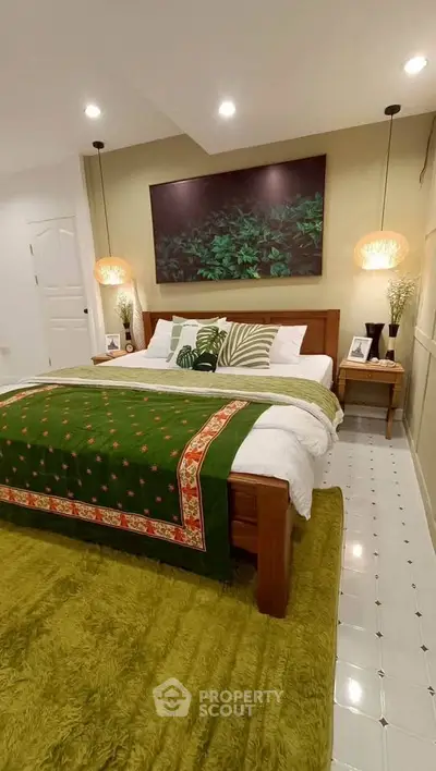 Cozy bedroom with green accents and modern decor, perfect for relaxation.