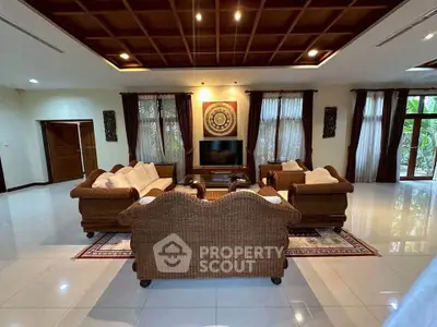 Spacious living room with elegant wicker furniture and large windows