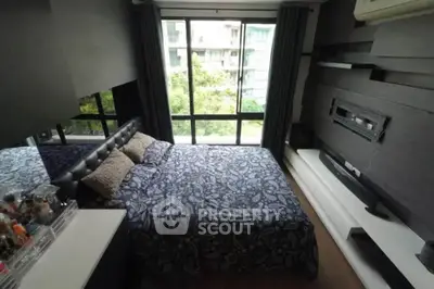 Cozy bedroom with large window and modern decor in urban apartment