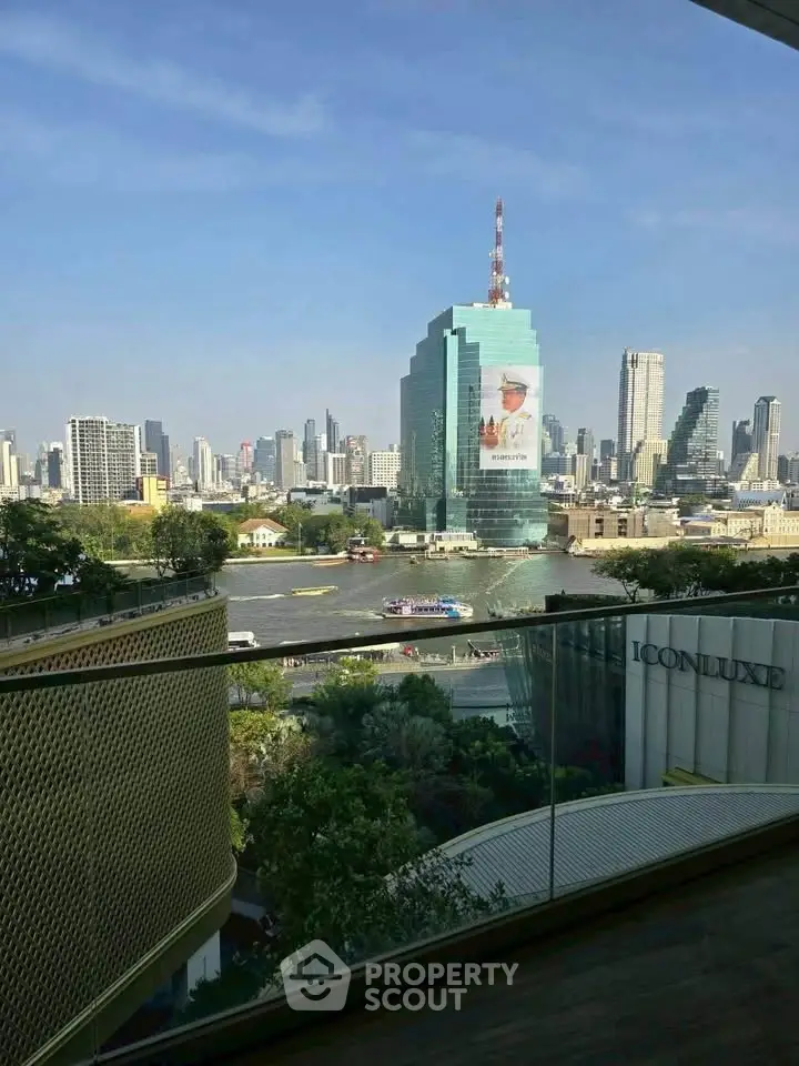 Stunning cityscape view from a high-rise balcony overlooking a river and skyline.
