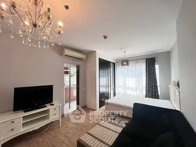 Elegant bedroom with chandelier, TV, and large windows in modern apartment