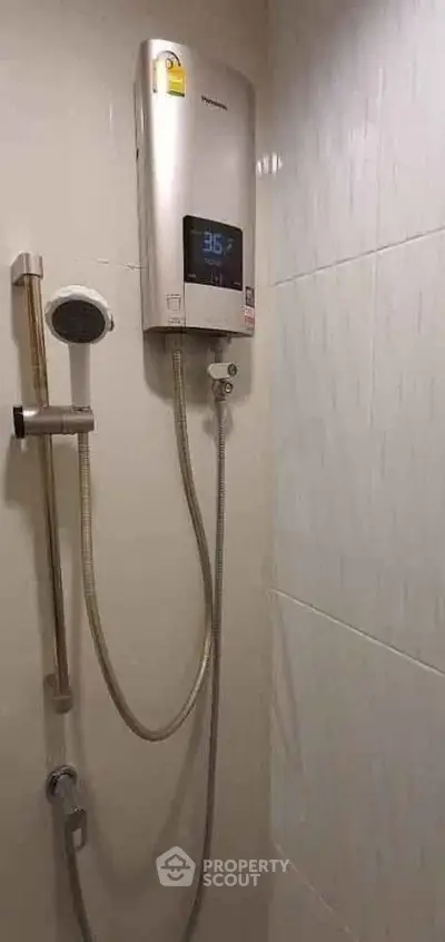 Modern bathroom with sleek shower unit and digital temperature display