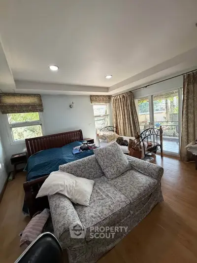 Spacious bedroom with elegant decor and balcony access