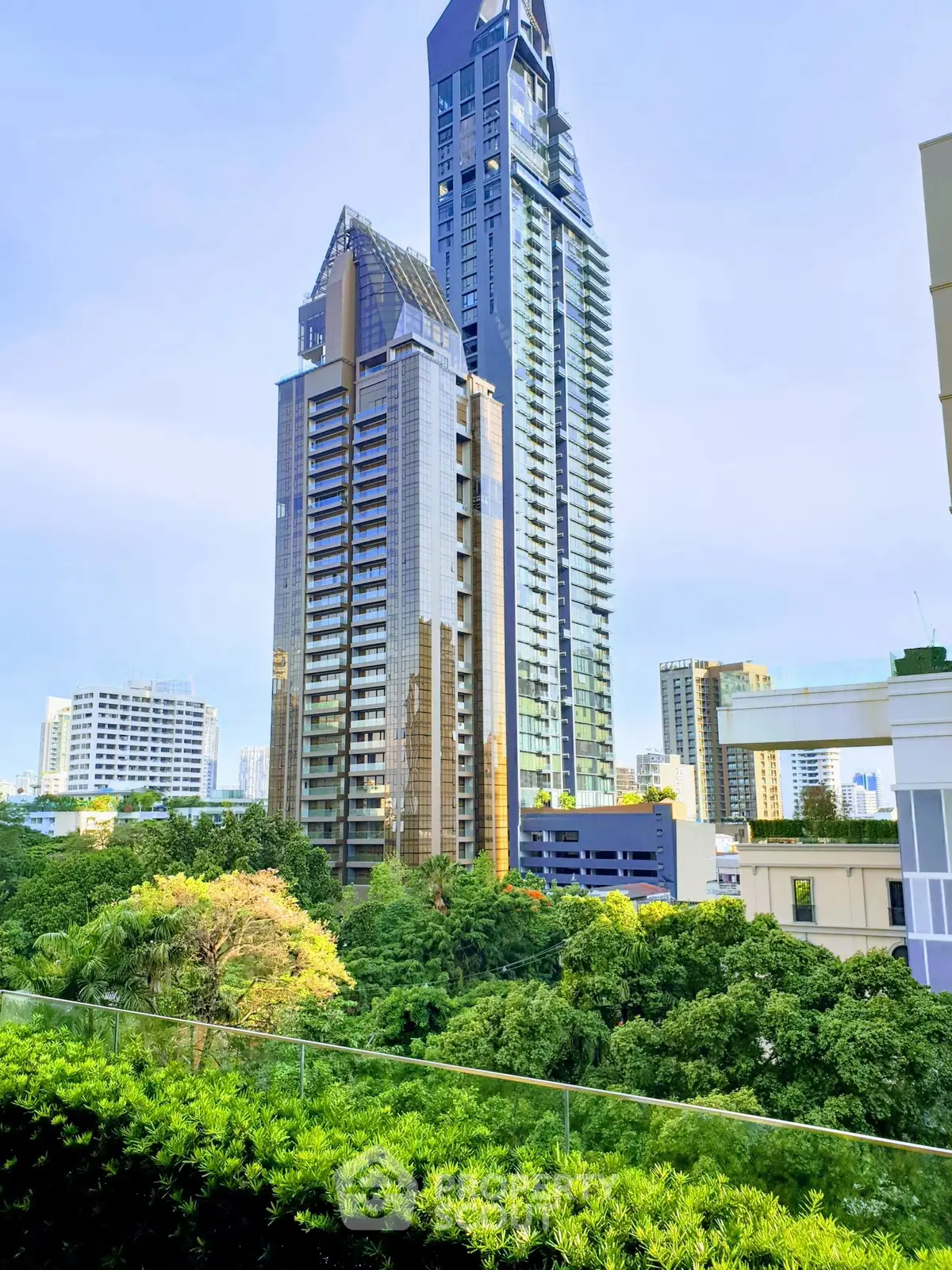 Stunning cityscape view featuring modern high-rise buildings and lush greenery, perfect for urban living.