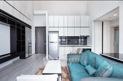 Modern open-plan living room with sleek kitchen and stylish furnishings