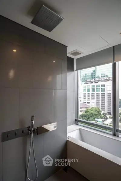 Luxurious bathroom with city view and modern fixtures in high-rise apartment