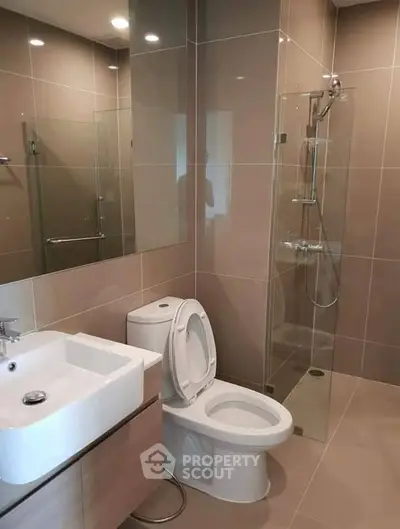 Modern bathroom with sleek fixtures and glass shower enclosure