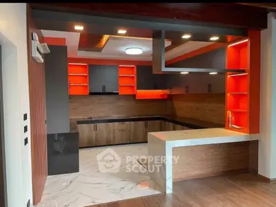 Modern kitchen with sleek design, featuring open layout and vibrant red accents, perfect for contemporary living.